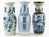 three blue and white vases sitting next to each other on a white surface