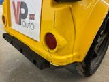 a yellow car with a sticker on the back of it