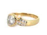 a close up of a diamond and gold ring on a white background