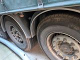 a green truck that is parked on the side of the road