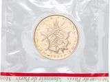 a close up of a coin in a plastic bag on a white background