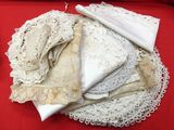 many different types of lace on a red table cloth