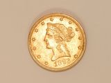 a close up of a gold coin with a woman ' s head on it