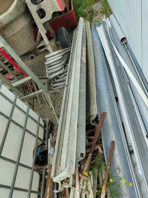 a pile of metal and wood outside of a building