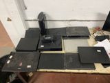 several laptops are sitting on a table in front of a white wall
