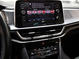 the interior of a car with a touch screen and a steering wheel