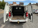 a white van with its doors open in a parking lot