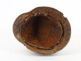 an old rusted piece of metal on a white surface