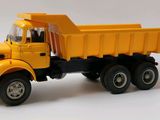 yellow toy dump truck on a white background with a white background