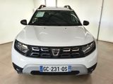 the front end of a white dacia parked in a garage