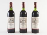 three bottles of wine sitting next to each other on a table