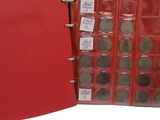 a red binder with lots of coins inside of it