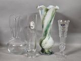 several glass vases and vases are sitting on a table
