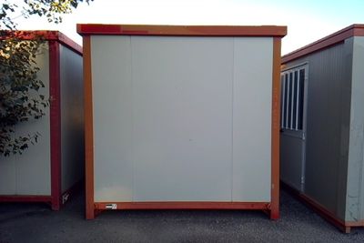 two portable buildings sitting next to each other in a parking lot