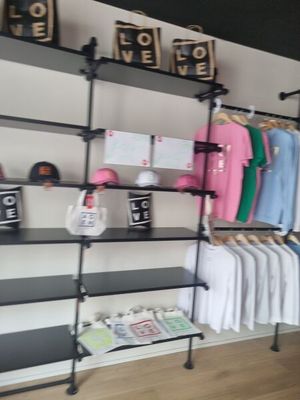 a rack with clothes and other items on it in a room