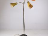 a pair of floor lamps with three shades on each of them