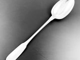 black and white photograph of a spoon on a table