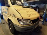 a van that is parked in a garage with the door open