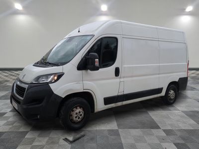 the white van is parked on a checkered tile floor