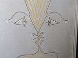 a picture of a drawing of a face on a white board