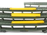 four green and yellow train cars sitting on a white surface