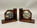a pair of bookends with a face on each of them