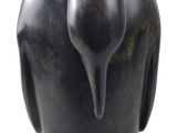 statue of a bird on a stand on a white background