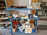 a blue shelf with boxes and other items on it