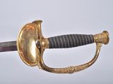 a gold and black sword with a black handle