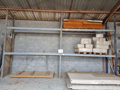 a room that has a lot of shelves and pallets in it