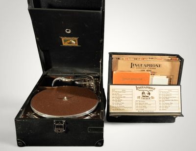 an old record player sitting in a suitcase with a record in it