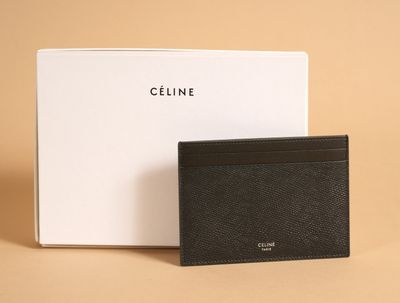 a black card case sitting next to a white box