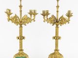 a pair of antique brass candelabs with green glass