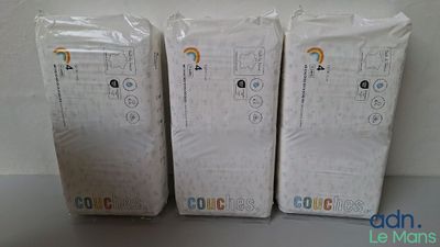 three boxes of toilet paper sitting on top of a table