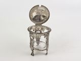 a small silver object with a glass inside of it