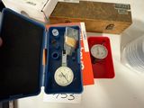 a person holding a watch in a box on a table