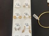 a lot of jewelry that is on display on the table