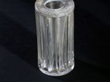 a clear glass vase with a small candle inside of it