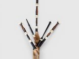 a bagpipe made out of wood and metal pipes on a white surface
