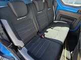 a seat in the back of a blue van