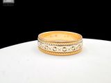 an image of a gold wedding ring on a table