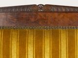 a wooden chair with a yellow velvet upholstered seat