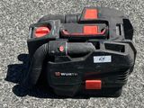a black and red vacuum sitting on the ground