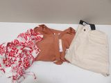 a pile of clothes that is on a white table