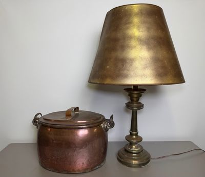 a lamp that is next to a pot on a table