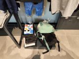 a dog that is laying on the floor next to a backpack