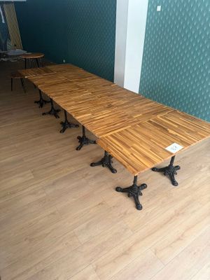 a long wooden table with four legs on it