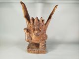 a small wooden sculpture of a bird on a table