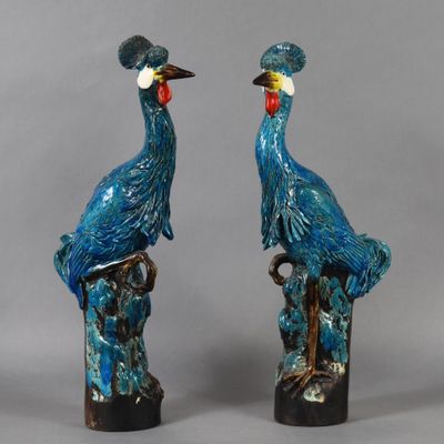 paire d'oiseaux en faïence bleue sur socles en bois, sur fond gris