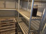 a metal shelf with baskets on it in a room